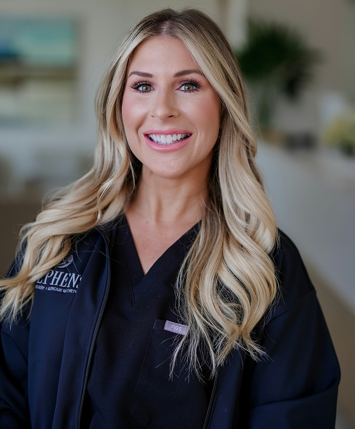 Smiling woman in professional medical attire.