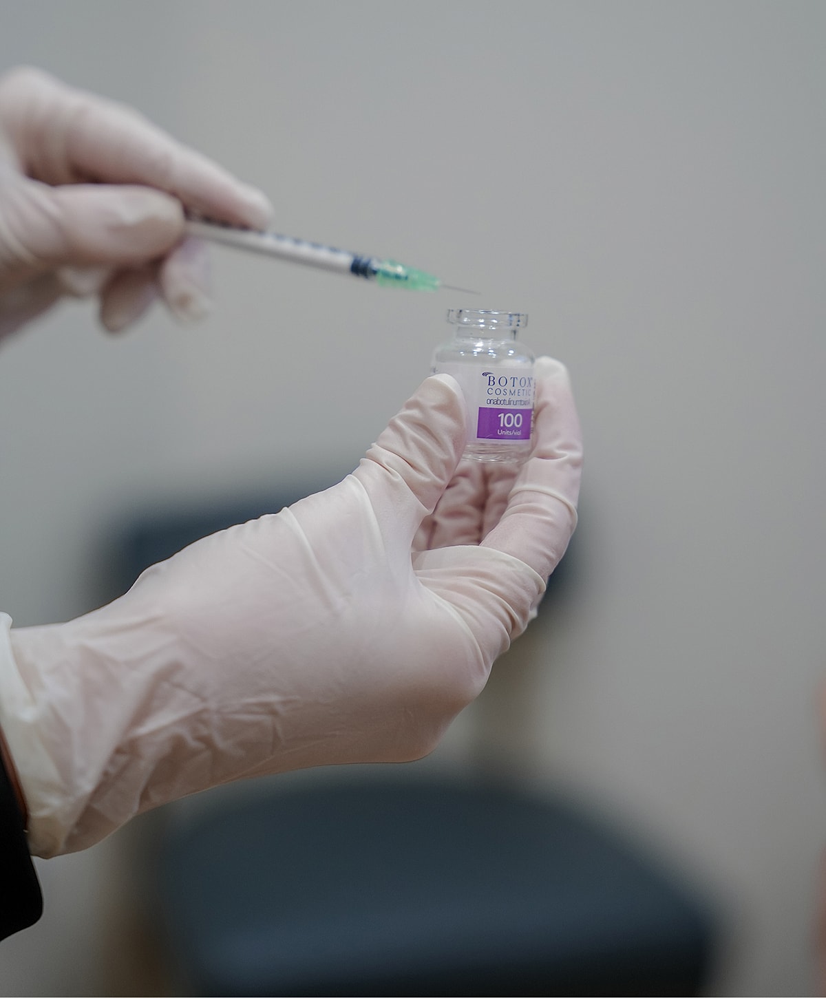 Syringe preparing cosmetic treatment vial.