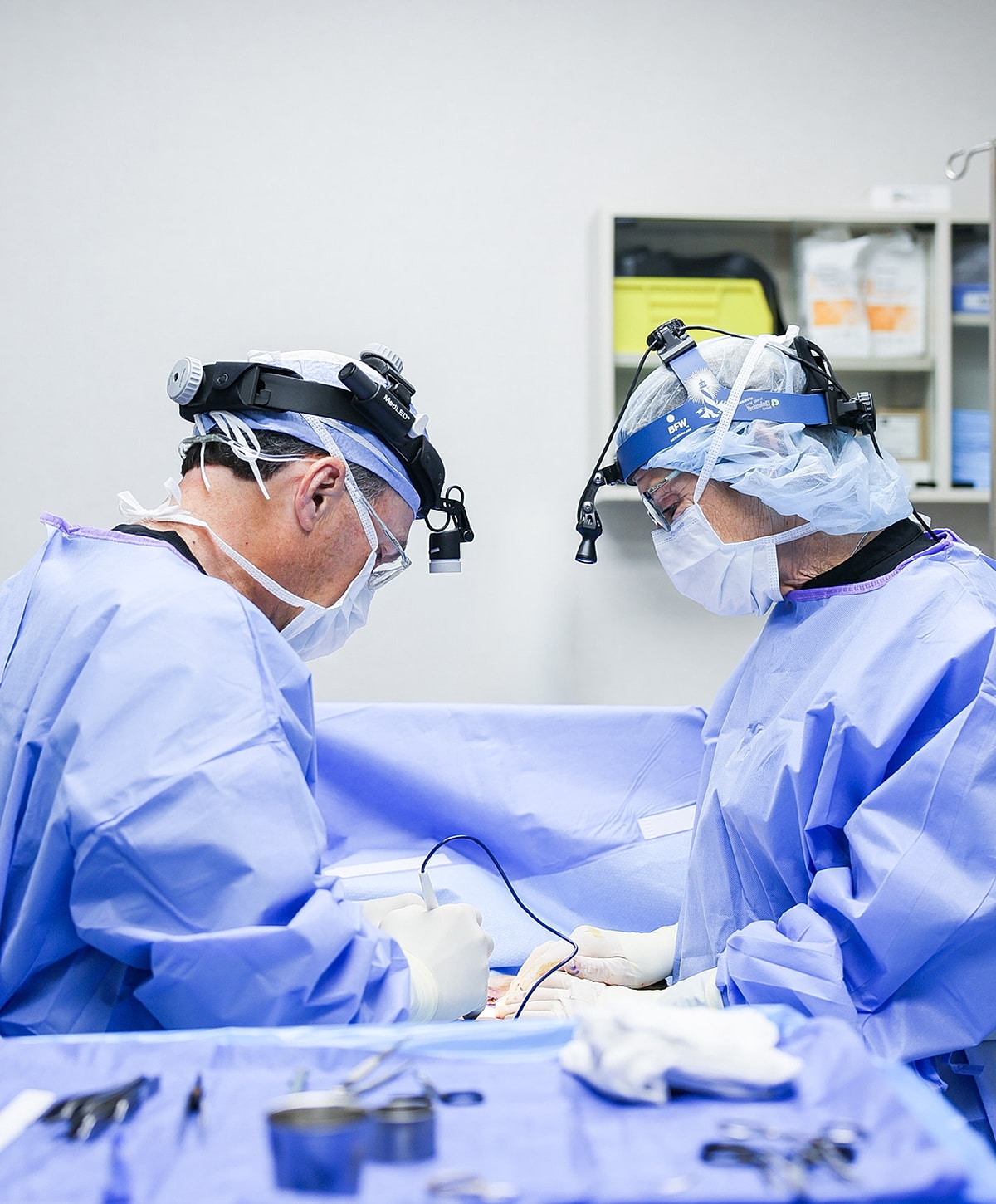 Surgeons performing surgery in a medical setting.