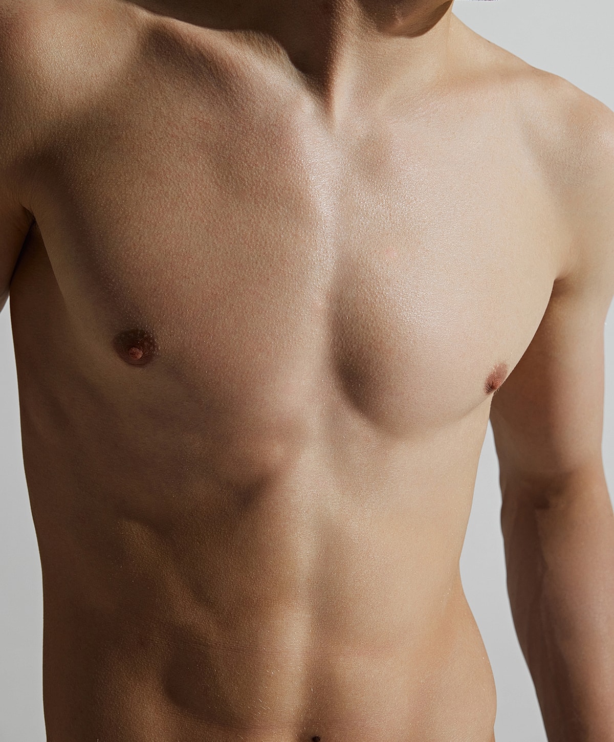 Close-up of male torso with defined muscles.