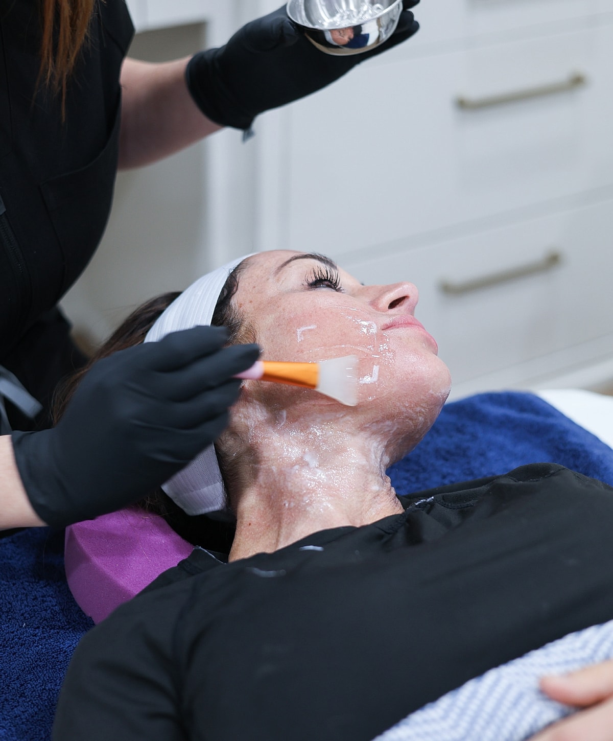 Facial treatment application with professional skincare products.