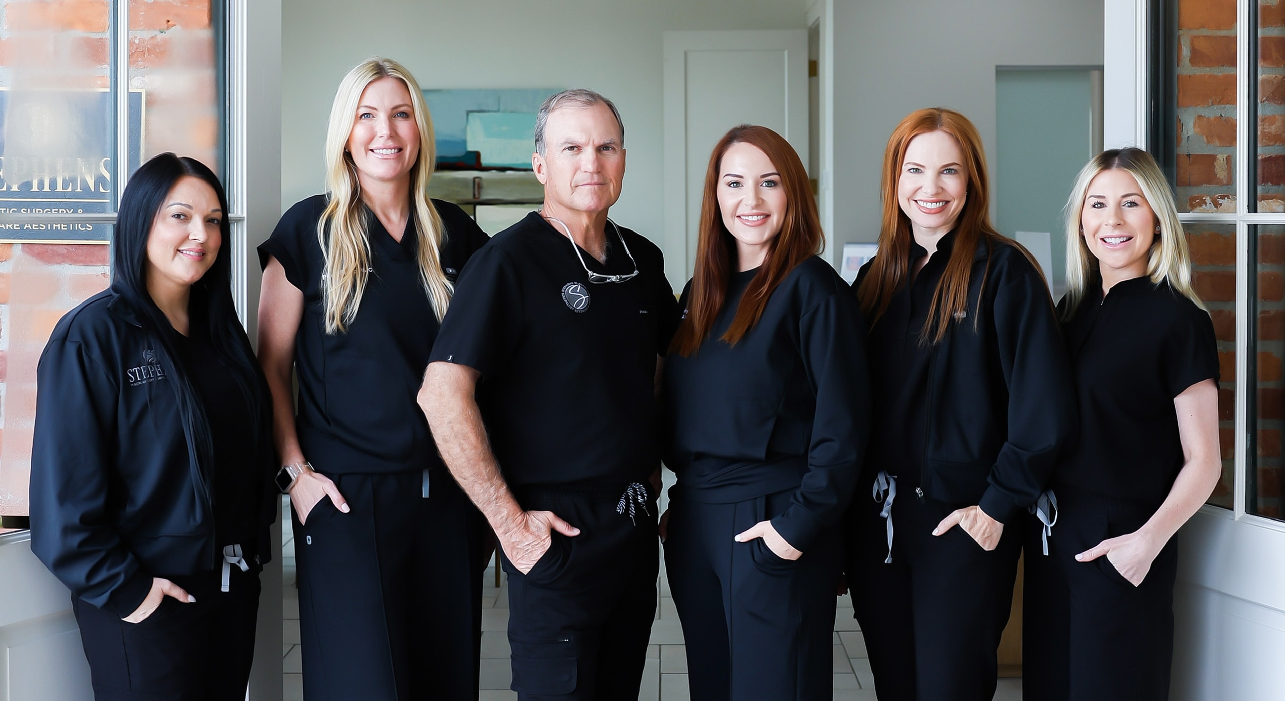 Group portrait of professionals in branded attire.