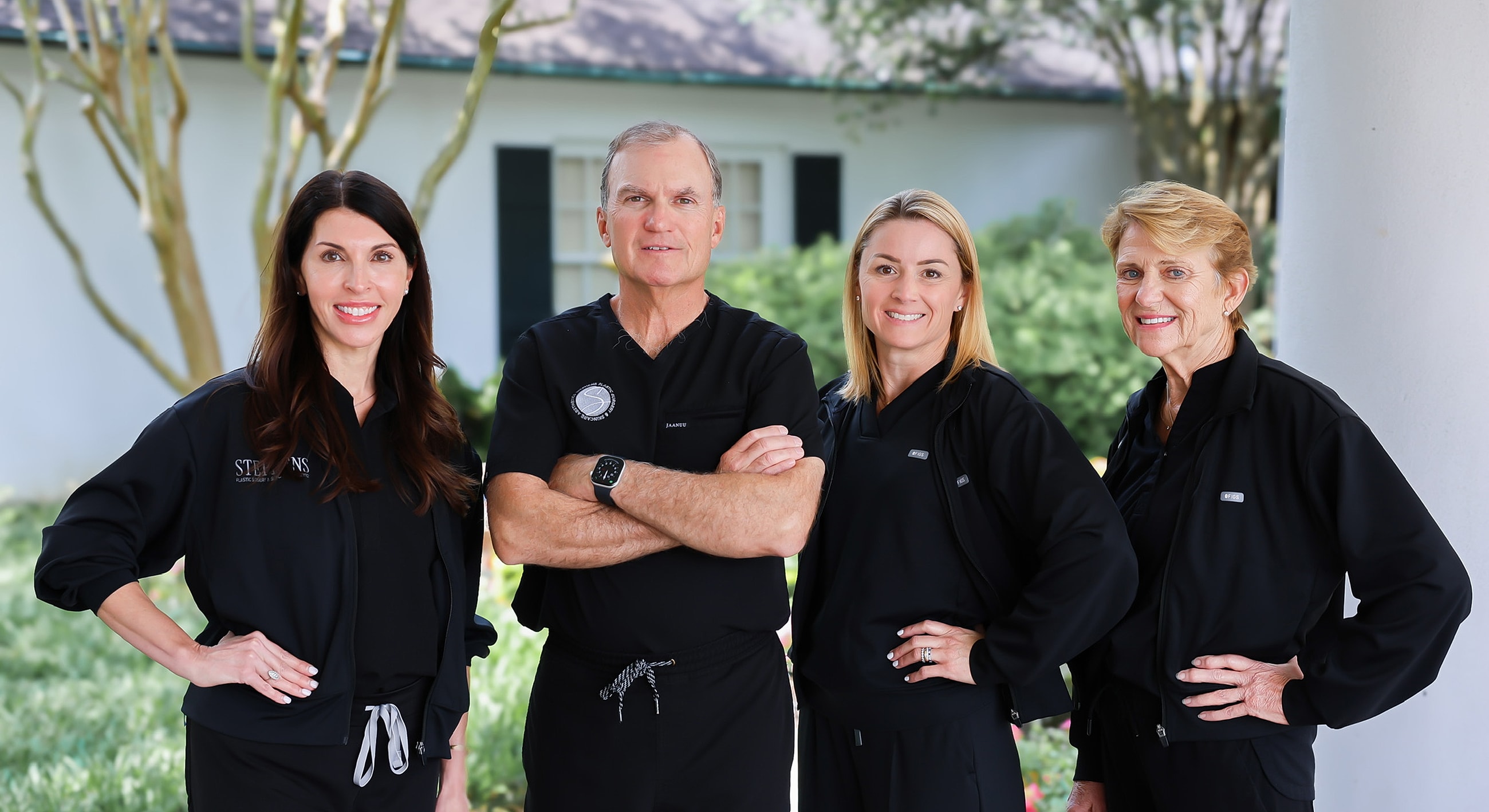 Medical professionals smiling in clinical setting.