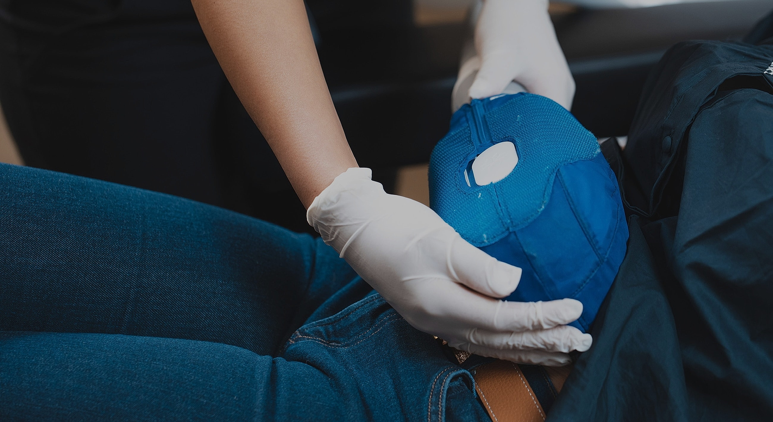 Medical professional applying a treatment to patient.