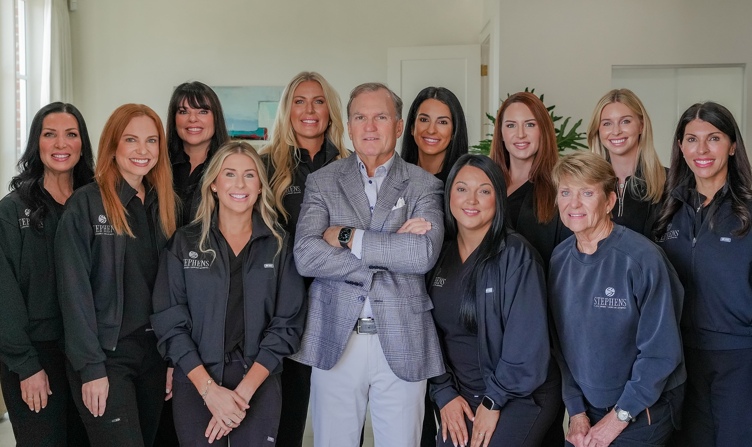 Professional team posing together in a bright office.