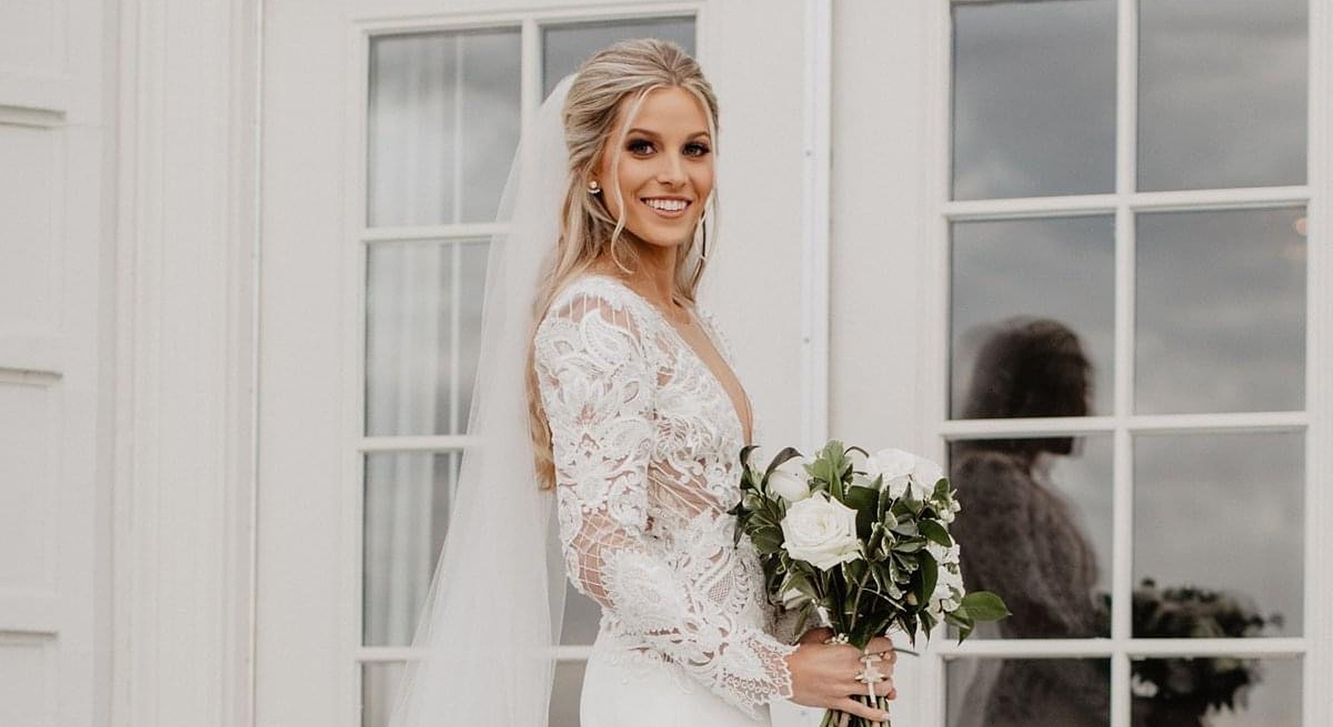 Bridal portrait with bouquet and elegant dress.